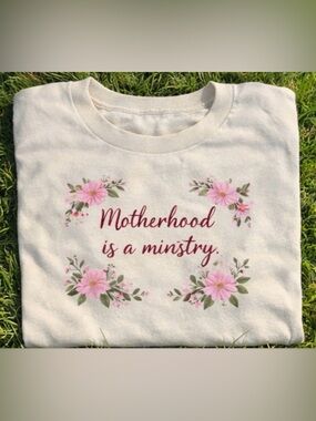 Mothers Day Motherhood Is a Ministry Floral Graphic Tee Cream with Pink Flowers